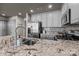 Kitchen island features granite counters, stainless appliances, and a stylish backsplash at 315 Arlington Ave # 705, Charlotte, NC 28203
