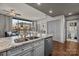 Modern kitchen with granite island and living room with floor to ceiling windows and sliding glass door at 315 Arlington Ave # 705, Charlotte, NC 28203