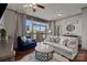 Bright living room with hardwood floors, ceiling fan, and floor to ceiling windows and sliding glass doors at 315 Arlington Ave # 705, Charlotte, NC 28203
