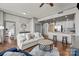 Cozy living room with hardwood floors, stylish furniture, and an open kitchen concept at 315 Arlington Ave # 705, Charlotte, NC 28203