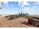 Spacious rooftop deck with skyline views offers ample seating for gatherings at 315 Arlington Ave # 705, Charlotte, NC 28203