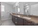 Contemporary bathroom featuring double sinks, sleek cabinetry, modern lighting, and a glass-enclosed shower at 324 Uptown West Dr, Charlotte, NC 28208