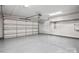 Spacious garage with ample storage, an automatic door, and sealed concrete flooring at 324 Uptown West Dr, Charlotte, NC 28208