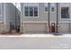 Garage of a tan townhouse with a red entrance door at 324 Uptown West Dr, Charlotte, NC 28208