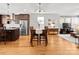 Open concept kitchen, dining and living area with hardwood flooring and stainless steel appliances at 324 Uptown West Dr, Charlotte, NC 28208