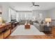 Bright living room with hardwood floors, large windows, ceiling fan, and comfortable seating for relaxation at 324 Uptown West Dr, Charlotte, NC 28208