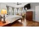 Spacious main bedroom with large windows, a ceiling fan, hardwood floors and plenty of natural light at 324 Uptown West Dr, Charlotte, NC 28208