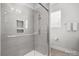Sleek shower with modern tile, glass door, and built-in shelving, offering a spa-like experience at 324 Uptown West Dr, Charlotte, NC 28208