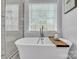 Bright bathroom featuring a freestanding tub and modern shower with frameless glass at 3565 Laboratory Rd, Lincolnton, NC 28092