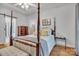 Charming bedroom featuring a four-poster bed, hardwood floors, and a bright, inviting atmosphere at 3565 Laboratory Rd, Lincolnton, NC 28092
