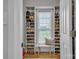 Walk in closet showing an organized shoe storage system and natural light from the window at 3565 Laboratory Rd, Lincolnton, NC 28092