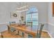 Inviting dining room with a farmhouse-style table, ample natural light from a large arched window at 3565 Laboratory Rd, Lincolnton, NC 28092