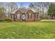Charming brick home featuring a well-manicured lawn, an inviting entrance, and tasteful landscaping at 3565 Laboratory Rd, Lincolnton, NC 28092