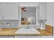 Stylish kitchen featuring butcher block counters, white cabinets, mosaic tile backsplash, and a sink at 3565 Laboratory Rd, Lincolnton, NC 28092