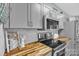 Well-designed kitchen featuring butcher block counters, stainless steel appliances, and charming decor at 3565 Laboratory Rd, Lincolnton, NC 28092