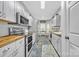 Bright kitchen features white cabinets, butcher block countertops, modern appliances, and tile flooring at 3565 Laboratory Rd, Lincolnton, NC 28092