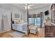 Elegant main bedroom features a four-poster bed, tray ceiling, and hardwood floors at 3565 Laboratory Rd, Lincolnton, NC 28092