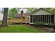 Charming backyard featuring a wooden deck and screened-in porch, perfect for outdoor entertaining at 413 Parallel Dr, Harrisburg, NC 28075