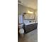 Bathroom featuring a gray vanity with double sinks, toilet, mirror, and tile floors at 413 Parallel Dr, Harrisburg, NC 28075