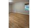 Bright bedroom features wood floors and a large window letting in ample natural light at 413 Parallel Dr, Harrisburg, NC 28075