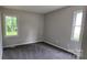 This bedroom offers neutral walls, carpet flooring, and two windows at 413 Parallel Dr, Harrisburg, NC 28075