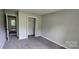 Neutral bedroom with carpet, closet, and windows letting in natural light at 413 Parallel Dr, Harrisburg, NC 28075