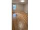 Bedroom featuring hardwood floors, neutral walls, and a large window at 413 Parallel Dr, Harrisburg, NC 28075
