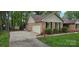 Well-maintained brick home with a two-car garage, manicured lawn, and charming landscaping at 413 Parallel Dr, Harrisburg, NC 28075