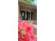 Charming brick home featuring a decorative front door and inviting porch with colorful flower accents at 413 Parallel Dr, Harrisburg, NC 28075