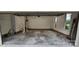 Spacious two-car garage with ample room for vehicles and storage, featuring brick perimeter and an entry door at 413 Parallel Dr, Harrisburg, NC 28075