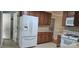 Kitchen features stainless steel refrigerator and wooden cabinets, perfect for Gathering meals at 413 Parallel Dr, Harrisburg, NC 28075
