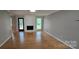 Bright living room boasting hardwood floors, a white-painted fireplace, and natural light at 413 Parallel Dr, Harrisburg, NC 28075