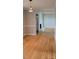 Hardwood floored living room featuring a fire place, neutral walls, and natural light at 413 Parallel Dr, Harrisburg, NC 28075