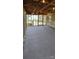 Cozy carpeted porch featuring wood framing and screening, with an entrance to a wood deck at 413 Parallel Dr, Harrisburg, NC 28075