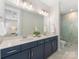 Modern bathroom featuring double sinks, a large mirror, and a glass-enclosed shower for a spa-like experience at 4141 Polluck Way, Charlotte, NC 28209