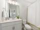 Clean bathroom with a framed mirror, white countertop, and walk-in shower with white curtain at 4141 Polluck Way, Charlotte, NC 28209