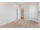 Bright bedroom with neutral carpet, white walls, and a doorway leading to another room at 4141 Polluck Way, Charlotte, NC 28209