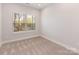 Bedroom with a large window offering natural light and views of the trees outside at 4141 Polluck Way, Charlotte, NC 28209