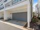 Attached single-car garage with gray door on a modern-style home at 4141 Polluck Way, Charlotte, NC 28209