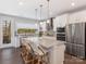 Bright kitchen features an island with bar seating, granite countertops, stainless appliances, and backyard views at 4141 Polluck Way, Charlotte, NC 28209