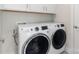 Laundry area with stacked white washer and dryer and white cabinets above at 4141 Polluck Way, Charlotte, NC 28209
