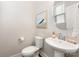 This powder room features a pedestal sink, toilet, and stylish decor for a convenient and elegant space at 4141 Polluck Way, Charlotte, NC 28209