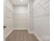 A well-organized walk-in closet featuring carpeted floors and wire shelving, creating a clutter-free space at 4141 Polluck Way, Charlotte, NC 28209