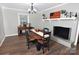 Charming dining area with decorative fireplace, modern lighting and hardwood flooring, perfect for cozy meals at 436 Old Nc 90 Hwy, Taylorsville, NC 28681