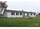 A lovely home featuring a brick exterior, black shutters, and a lush green lawn at 436 Old Nc 90 Hwy, Taylorsville, NC 28681