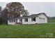 Charming white brick home with black shutters, solar panels, and a well-manicured lawn at 436 Old Nc 90 Hwy, Taylorsville, NC 28681