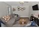 Comfortable living room featuring a gray sectional sofa, ceiling fan, and modern decor at 436 Old Nc 90 Hwy, Taylorsville, NC 28681