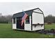 Exterior shot of white shed with black accents and the American flag in a grassy yard at 436 Old Nc 90 Hwy, Taylorsville, NC 28681