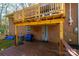 A view of the upper and lower wooden deck and brick home, from the backyard at 444 27Th Avenue Nw Cir, Hickory, NC 28601