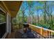 View from the deck of the wooded backyard with outdoor seating and a grill at 444 27Th Avenue Nw Cir, Hickory, NC 28601